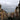 a city street lined with tall buildings under a cloudy sky