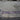 Purple ni una menos graffiti on a building wall.